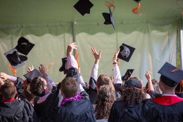  a crowd throwing their caps at graduation